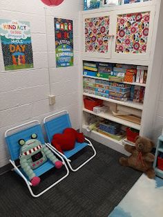 two children's toys in a playroom with bookshelves and posters on the wall