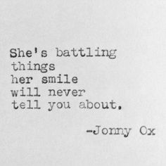 an old typewriter with the words she's battling things her smile will never tell you about