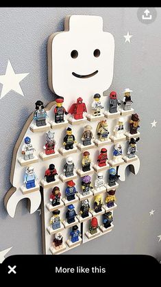 a wall mounted lego figure display on the side of a gray wall with white stars