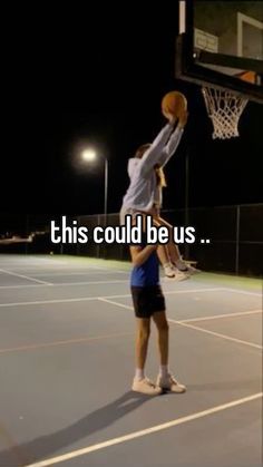 a man holding a basketball up in the air