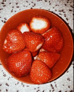 a bowl filled with lots of ripe strawberries