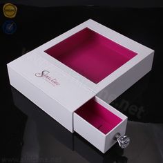 an open white box with pink lining