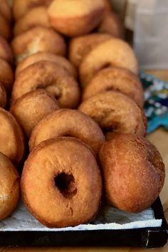 a bunch of doughnuts that are sitting on a table together in a row