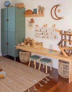 a child's room with toys and decor on the wall, including a desk