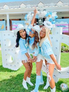 three girls in blue and white outfits posing for the camera