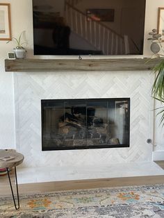 a television mounted above a fireplace in a living room