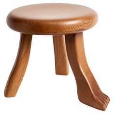 a small wooden stool sitting on top of a white floor