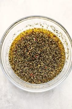 a glass bowl filled with spices on top of a table