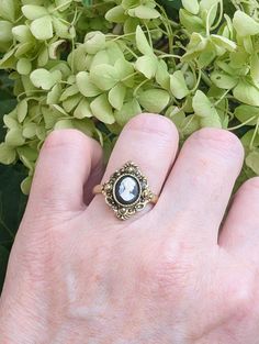 An enchanting cameo ring that features a classic portrait of a Grecian Goddess in a bezel setting. Resembling a kite-shaped shield, the ring face is decorated with ornate milgrain detailing. SIZE: This ring is adjustable, which is convenient if you aren't sure what size your recipient's finger is or if you like wearing rings on different fingers.  To resize the ring, simply slide apart the two pieces on the back or underside of the ring and push them together. The smallest I can manage the ring Wearing Rings, Classic Portrait, The Ring Face, How To Wear Rings, Grecian Goddess, Classic Portraits, Victorian Costume, Cameo Earrings, Vintage Inspired Jewelry