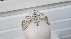 Handmade crystal ballet headpiece in your choice of pastel colour (pictured is light blue with gold and pearl). Suitable for many ballet roles, such as Swan Lake Pas de Trois, Princess Florine (Bluebird), Odalisque, Gulnare, Medora, Pas d'Esclave, Talisman, Raymonda, and more. Made with crystal beads, acrylic pearls, a crystal bead droplet, and a crystal teardrop jewel.  Shipping Information: - Shipping to the United States and Canada takes approx. 4 to 14 working days. - Shipping to the United Ballet Crowns, Ballet Tiaras, Ballet Headpieces, Swan Lake, Costume Hats, Costume Accessories, Colorful Pictures, Blue Bird, Tiara