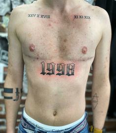 a shirtless man with roman numerals on his chest and the number nine