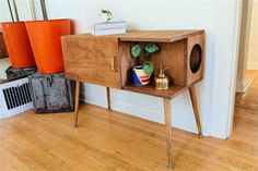 a wooden cabinet sitting on top of a hard wood floor