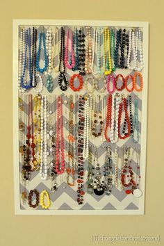 the diy jewelry organizer is organized and ready to be hung up on the wall