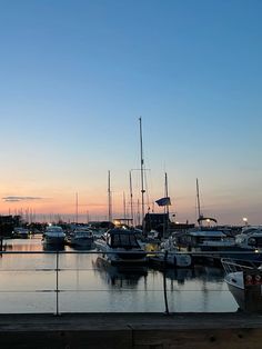 boats are docked in the harbor at sunset