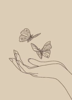 two butterflies flying in the air above a hand