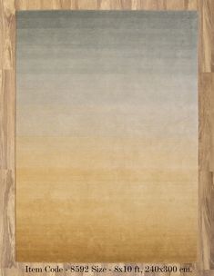 an area rug with wood flooring in the middle and light brown, blue, yellow and grey colors