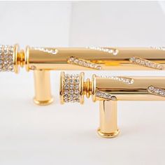 two gold - plated rollers with diamonds on them are sitting next to each other