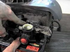 a man is working on an engine in his garage with the help of a wrench