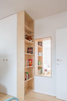 an empty room with bookshelves and toys in it