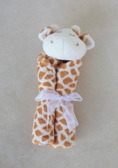 a giraffe stuffed animal wrapped in a blanket