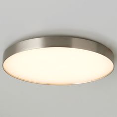 a close up of a light fixture on a ceiling with white walls in the background