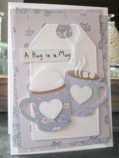 a card with two mugs on it and the words, hug in a mug