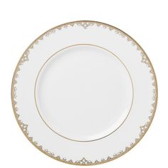 an empty white plate with gold trimmings on the rim and bottom, against a white background