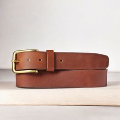 Handmade in our Toronto studio, Elara is a full grain leather belt that features an elegant, gold rectangular buckle. This versatile accessory can be worn as a waist belt to cinch a dress or as a classic belt with high-rise jeans. The name Elara, inspired by the moon of Jupiter, signifies the celestial beauty and timeless appeal of this exquisite belt. Just as Jupiter’s moon Elara orbits the giant planet with grace, this belt encircles your waist with sophistication and elegance, making it a che Formal Adjustable Belt With Removable Feature, Adjustable Formal Belts And Suspenders, Gold Leather Belt With Rectangular Buckle, Chic Leather Belt With Brass Buckle, Elegant Adjustable Belt Buckles With Brass Buckle, Elegant Belts With Brass Buckle, Elegant Adjustable Belt Buckle With Brass Detail, Adjustable Gold Belt Buckles, Gold Leather Rectangular Belt Buckle