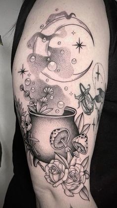 a woman's arm with a pot and flowers on it