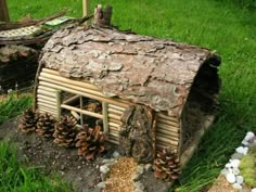 a house made out of logs and pine cones