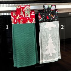 two kitchen towels hanging on the oven rack