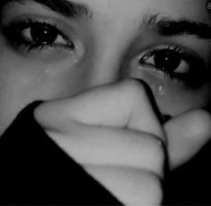 black and white photograph of a woman's face with her hand on her nose