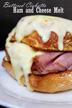 ham and cheese melt sandwich sitting on top of a white plate