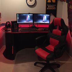 a computer desk with two monitors and a gaming chair