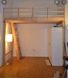 a loft bed is built into the side of a wall with a ladder to it