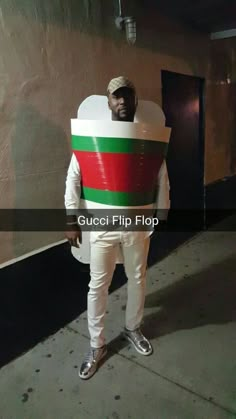 a man dressed in a costume that looks like a giant piece of food is standing on the sidewalk