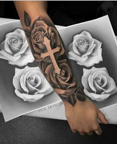 a man's arm with roses and a cross on it