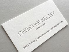 a white business card with the words, christine kesey interiors on it's side