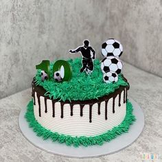 a birthday cake with soccer decorations on top