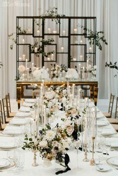 a long table is set with white flowers and candles for an elegant wedding reception at the four seasons resort