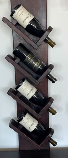 a wooden wine rack holding three bottles of wine