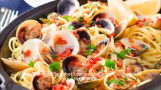 pasta with clams and sauce in a skillet