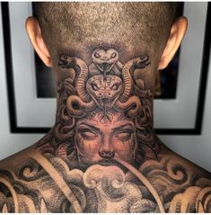 a man's neck with an intricate tattoo design on it