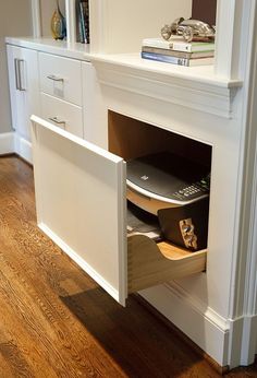 a white entertainment center with an open door