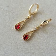 Ruby Red & Crystal Teardrop Teardrop Jewel Huggie Hoop Earrings, 14k Gold Plated Earrings, Vintage Style Earrings, Victorian Earrings Product specifications: * Material: 14K Gold Plated Brass * Size Each charm measures 1.8 cm x 0.6 cm.  Earring Options: * 8mm inner diameter lever back hoops (1.1cm outer diameter, 1.5cm drop) * 10mm inner diameter lever back hoops (1.3cm outer diameter, 1.6cm drop) Packaging and Gifts: * All pieces of jewellery are set on a card in a mesh jewellery pouch  Shippin Red Teardrop Hoop Earrings With Ear Wire, Red Teardrop Hoop Earrings, Red Teardrop Hoop Earrings For Pierced Ears, Elegant Red Huggie Hoop Earrings, Red Hypoallergenic Dangle Hoop Earrings, Red Huggie Earrings For Anniversary, Valentine's Day Teardrop Earrings, October Jewelry, Red Ruby Earrings