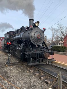 an old fashioned steam engine on the tracks