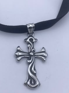 vintage Celtic silver Stainless Steel Cross pendant necklace Very solid Gothic cross Vintage design  Silver stainless steel  Over an inch Hangs on a velvet ribbon,  Can be worn on a chain.  All jewelry is shipped in a nice gift box.   Check out our over a THOUSAND great reviewsh Antique Silver Cross Pendant Necklace For Gift, Cross Necklace Gothic, Silver Gothic Cross Necklace, Gothic Silver Pendant Cross Necklace, Gothic Stainless Steel Cross Necklace, Gothic Stainless Steel Cross Pendant Jewelry, Cross Choker Necklace, Stainless Steel Cross Pendant, Cross Choker