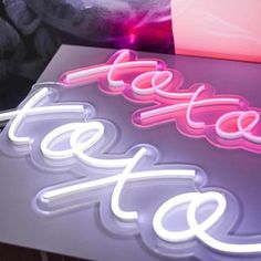 a neon sign that is sitting on top of a table