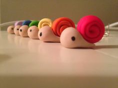 a row of small toy snails sitting on top of a table