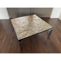 a marble top coffee table with metal legs